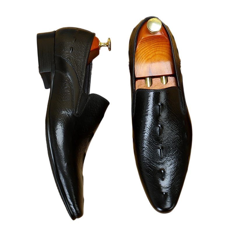 A pair of men's premium black leather loafers with a classic croc-embossed skin pattern, elegant slip-on dress shoes for formal wear.
