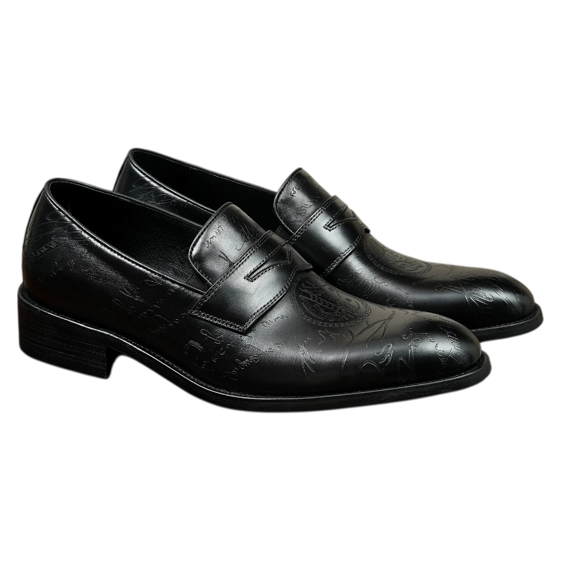 A pair of men's premium black leather loafers with a luxury metallic emblem hardware accent, stylish slip-on dress shoes for formal events.

