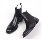 Black leather Chelsea boots, angled side view with elastic gore and tapered toe