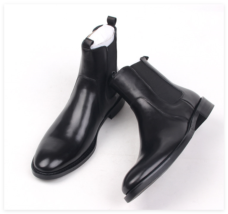 Black leather Chelsea boots, angled side view with elastic gore and tapered toe