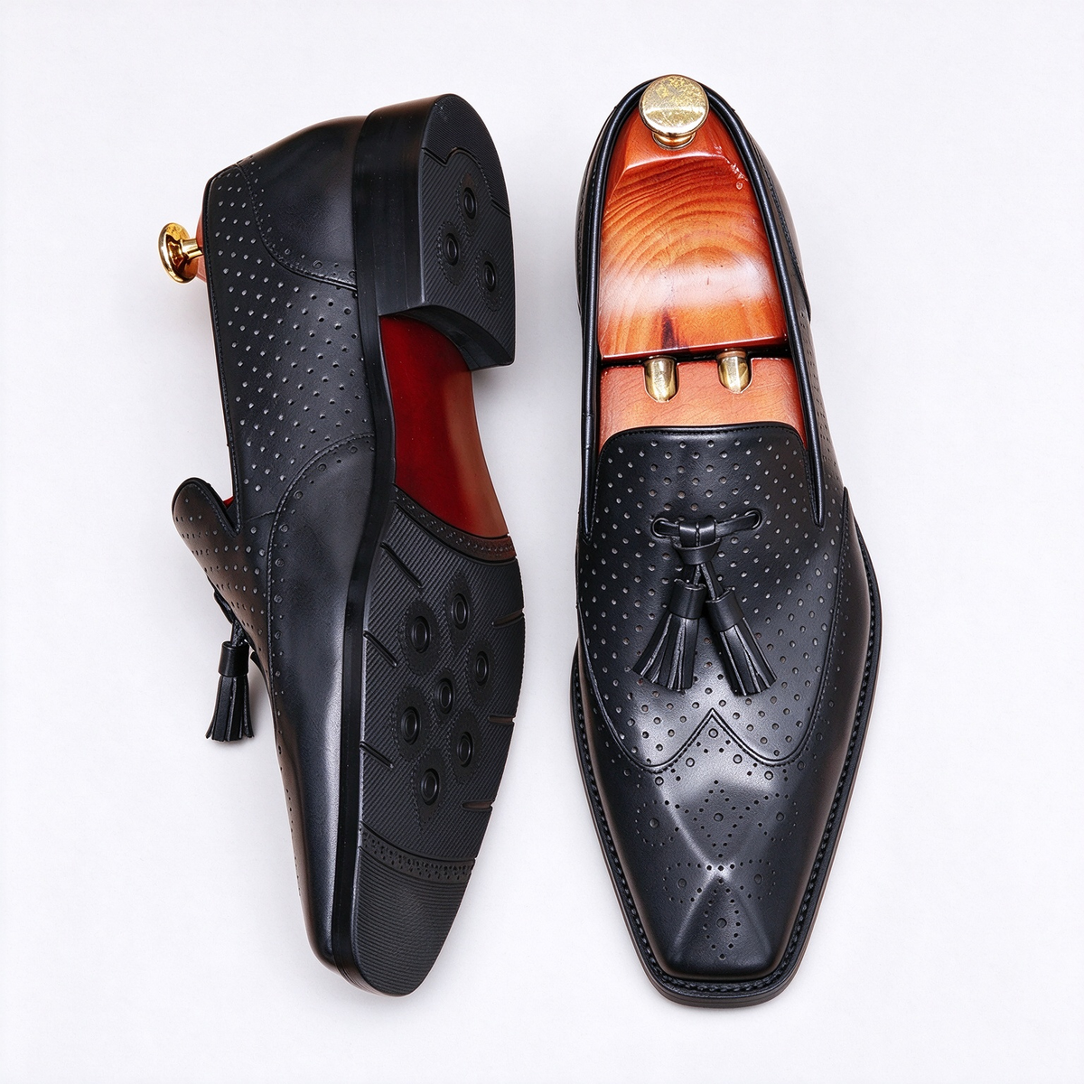 Pair of men's exotic leather loafers in sleek black, designed as slip-on dress shoes for formal wear.
