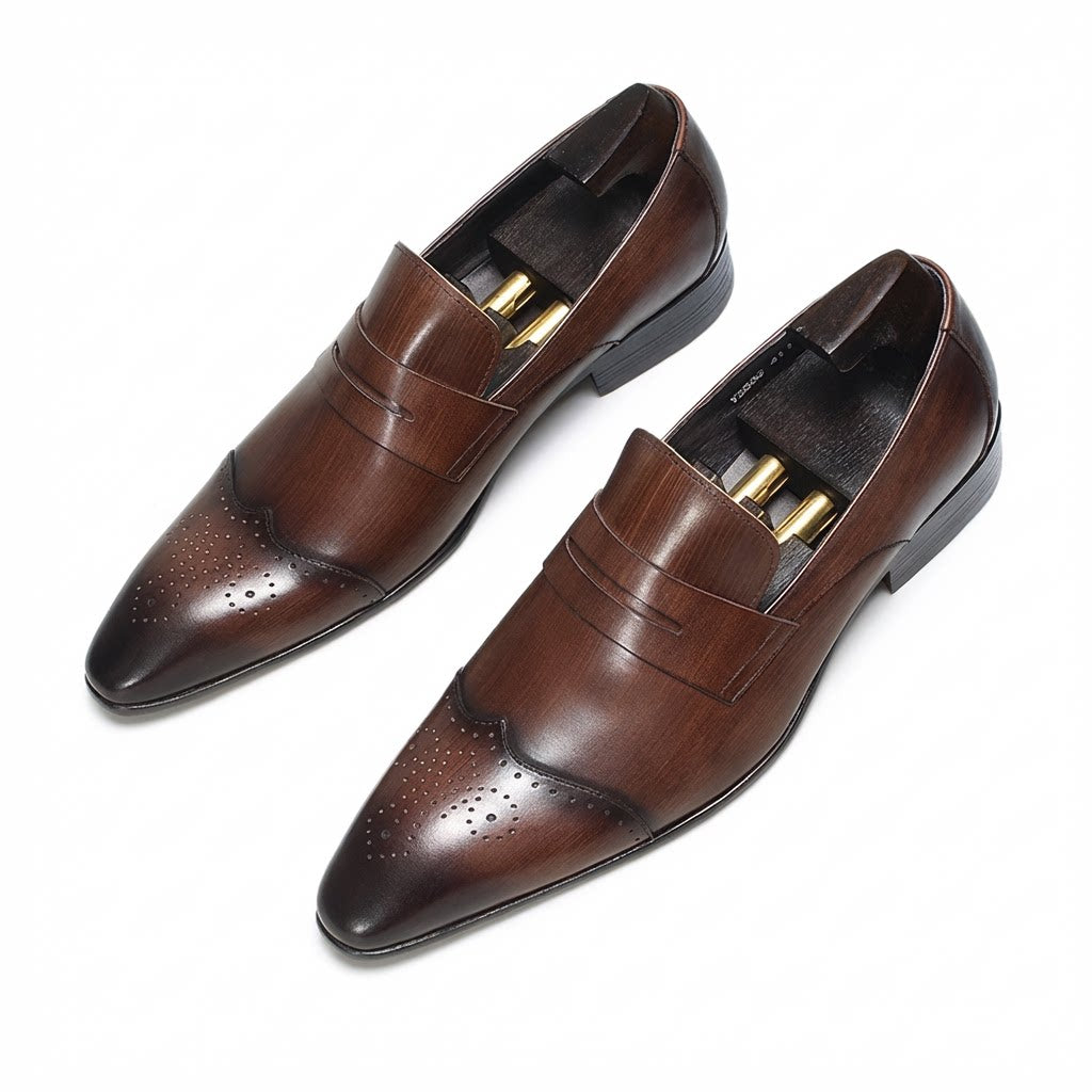 Elegant brown wingtip brogue leather slip-on loafers featuring a classic perforated design.