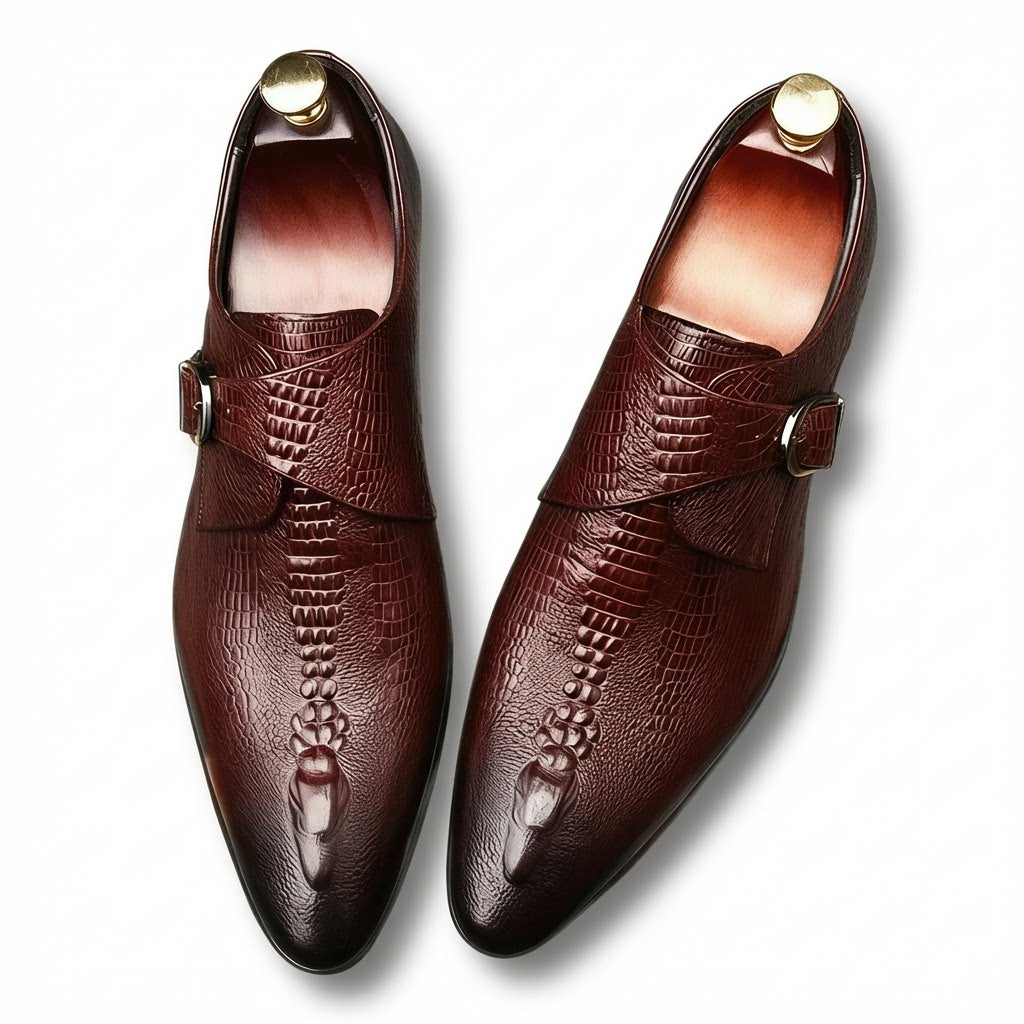 Elegant burgundy crocodile patterned leather monk strap shoes with a sleek professional silhouette.
