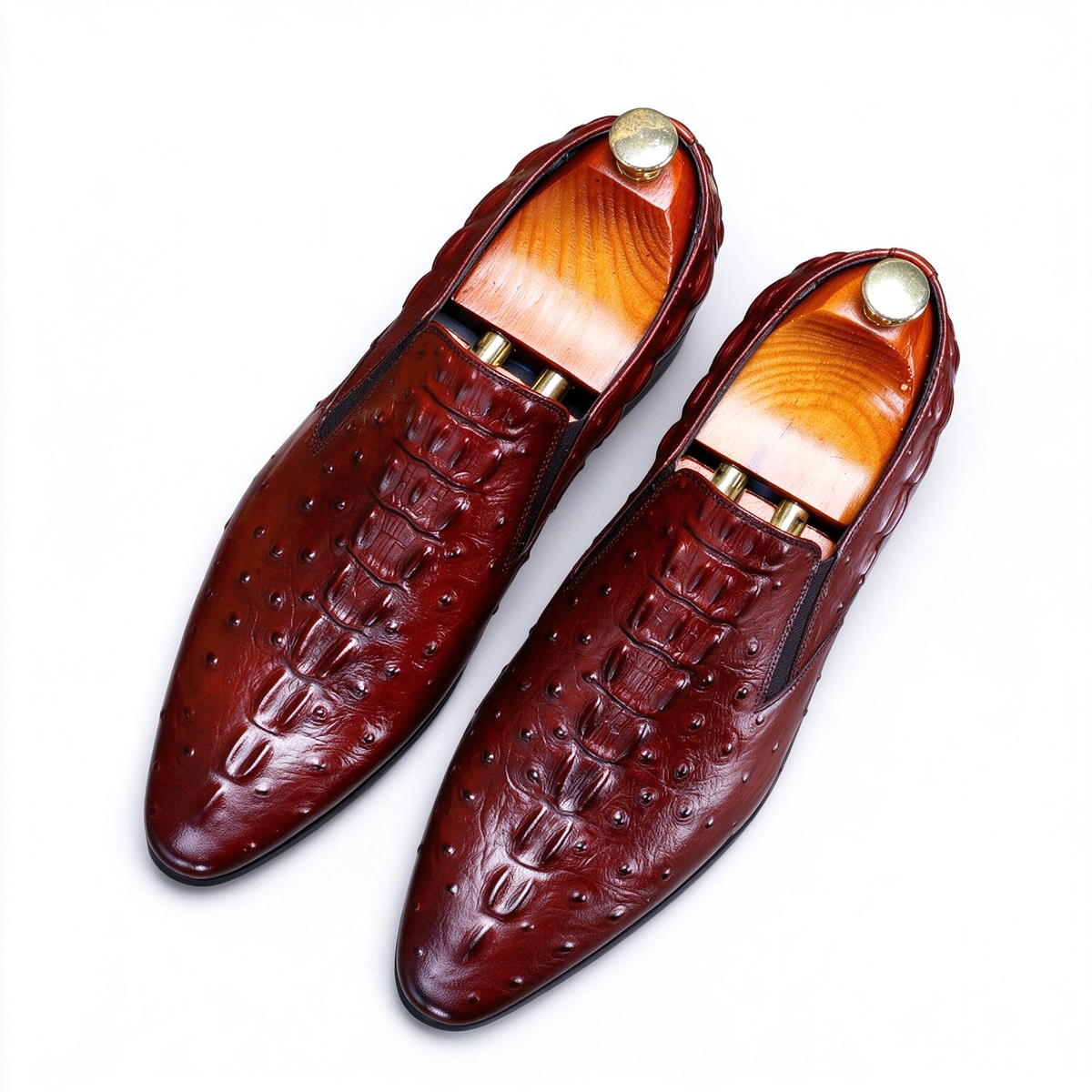 Men's burgundy exotic leather loafers, elegant luxury dress shoes with a textured finish.
