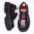 Men's burgundy leather loafers with a thick chunky sole, stylish slip-on dress shoes in a deep wine red finish.
