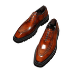 Men's brown wingtip brogue oxford shoes with chunky lug sole and lace-up design