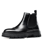 Black leather chelsea dress boots with elastic gore, wingtip brogue detailing, thick sole