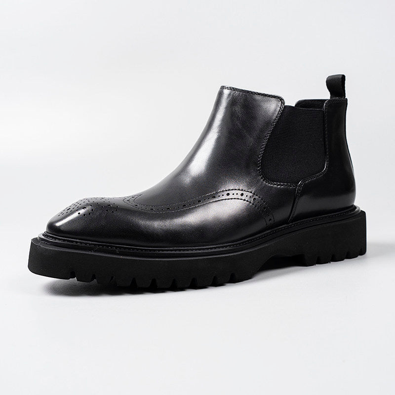 Black leather Chelsea dress boots with side elastic panels and brogue-style perforations