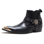 Black leather Chelsea dress boots, slip-on with side gore and decorative buckle charm.
