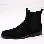 Black suede Chelsea boots with elastic side panels and dark low block heel