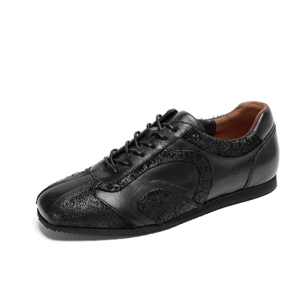 Men's black leather sneakers with lace-up front and textured side panels