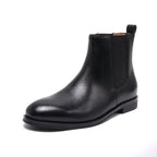 Black pointed-toe Chelsea boot with elastic side panels and low block sole