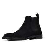 Black Chelsea dress boot with side elastic gore and low stacked heel, slip-on style.