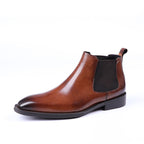 Brown leather Chelsea boots with elastic side gore, slip-on design, and black sole