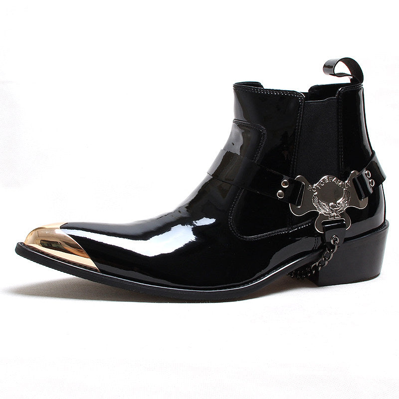 Black shiny leather Chelsea boots with slip-on gore, decorative buckle at ankle.