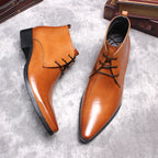 Tan leather lace-up dress boots with pointed toe, decorative seams, and low heel.
