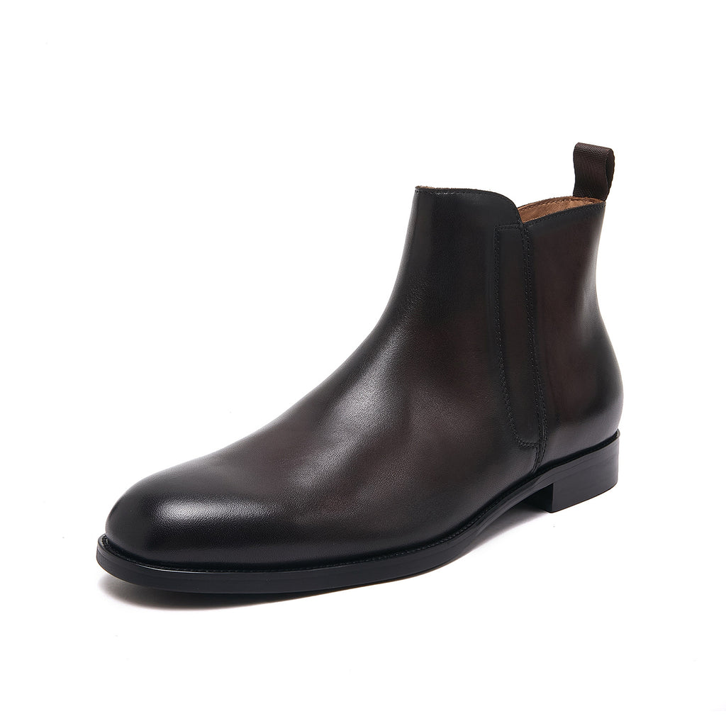 Pointed-toe leather side-zip dress boot in black, front three-quarter view on white